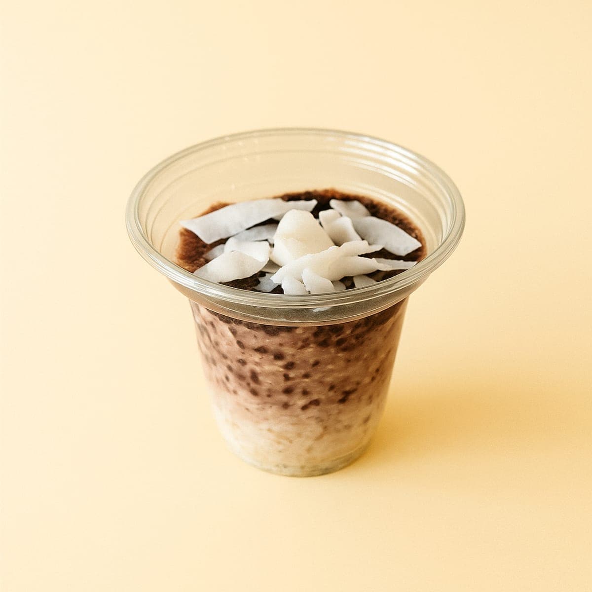 Chocolate overnight oats topped with coconut flakes